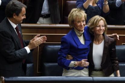 El presidente del Gobierno mira cómo se abrazan Salgado y De la Vega, esta mañana en el Congreso de los Diputados.