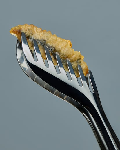 El boquerón se prepara con una tempura especial hecha con manzanilla en lugar de agua o cerveza, logrando un rebozado sutil que realza el sabor del pescado.