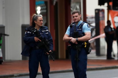 Police stand guard at a cordoned off area near the site of a shooting, in Queen Street, Auckland, New Zealand, 20 July 2023.