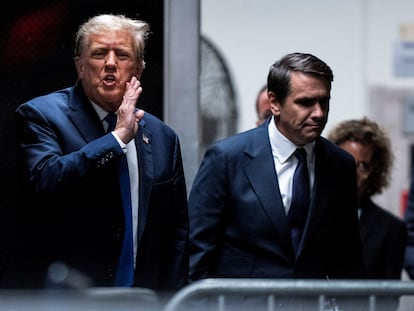 Former U.S President Donald Trump speaks with attorney Todd Blanche as they return from a lunch break at Manhattan criminal court as jury selection continues in New York, April 18, 2024.