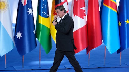 Bolsonaro tira a máscara para posar ao lado de Mario Draghi na chegada à cúpula do G20, em Roma, neste sábado.