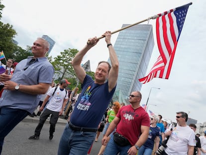 U.S. Ambassador Mark Brzezinski holds a U.S. flag as he marches in the yearly pride parade in Warsaw, Poland, on Saturday, June 17, 2023.