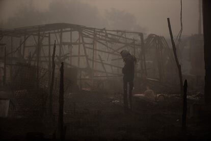 Un migrante contempla la zona calcinada tras el incendio en el campamento de Calais.