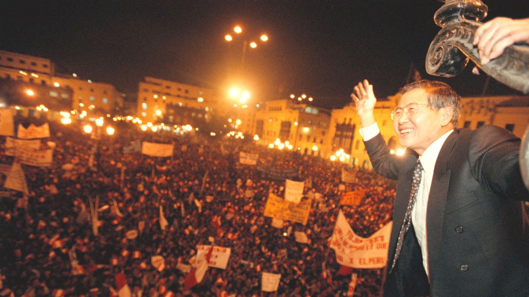  Peruvian President Alberto Fujimori greets his supporters outside the presidential palace September 19, 2000 in Lima, Peru. Fujimori's supporters came to show their support for him to plead not to leave the government. Peru's opposition has called for the swift creation of an emergency government, clamoring for Fujimori to step down quickly amid a bribery scandal engulfing his spy chief Montesinos. Fujimori announced he would call new elections and wouldn''t run, ending a decade in power. He also pledged to dismantle the much-criticized National Intelligence Service. (Photo by Newsmakers)