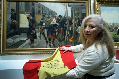 Liliana Rodríguez, con la bandera de su abuelo, en el Museo del Ejército, ante el óleo 'La despedida', de José Cusachs.