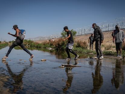 A group of migrants crosses the Rio Bravo in Ciudad Juarez, Mexico, on their way to the United States.