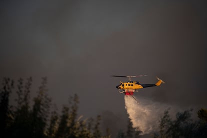 Un helicóptero antincendios arroja agua en el incendio forestal de Varnava, el domingo. 