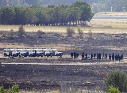 Civil Guard officers inspect the location of the Spanair accident at Madrid's Barajas airport in August 2008.