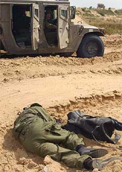 Varios soldados israelíes hallan de cuerpo de uno de los dos palestinos abatidos junto al asentamiento de Morag.