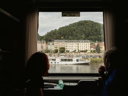 A couple looks out over the Elbe River in Germany from the train that will take them to Prague.