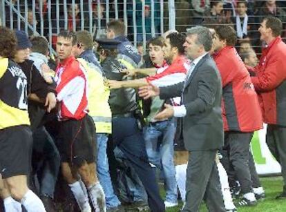 Entrenador y jugadores del Eindhoven ayudan a desalojar a los hinchas.
