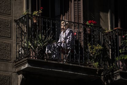 Una mujer sentada en su balcón en el centro de Barcelona, el 7 de mayo de 2020. 