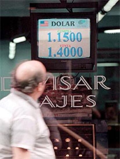 Una persona observa el viernes  la cotización del dólar frente al peso.