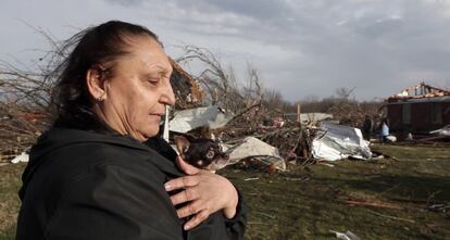 Jeanie Lewellyn y su perro Bell Bell observan los restos de su hogar, destruido por un tornado en Nuevo Pek&iacute;n (Indiana).
