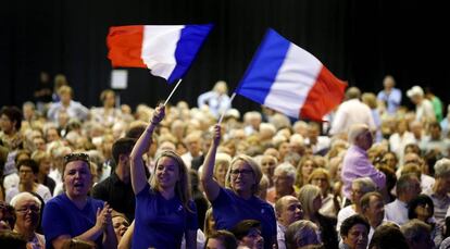 Dos simpatizantes de Fillon agitan una bandera de Francia en un mitin de campa&ntilde;a