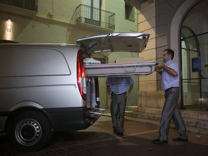 Funeral service workers leave the Dalí Theatre-Museum in Figueres, Spain.