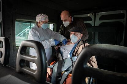 Lorenzo García, de 93 años, recibe la primera dosis de la vacuna acompañado de su hijo Manolo, dentro de una furgoneta adaptada para silla de ruedas.