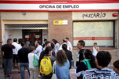 People lining up in front of an unemployment office.