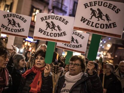 People in Barcelona march in support of refugees.