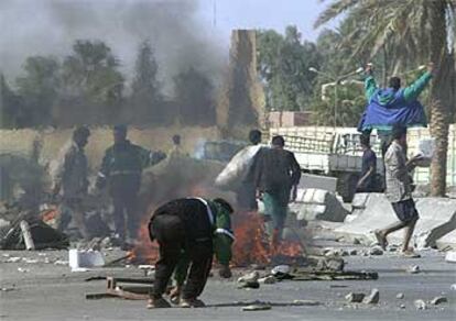 Varios hombres lanzan piedras contras las tropas de Estados Unidos, ayer en Abu Ghraib, cerca de Bagdad.