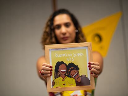 Anielle Franco, Brazil's ministrer for Racial Equality holds a portrait of herself and her sister, Marielle, who was killed five years ago today.