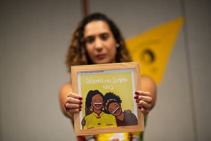 Anielle Franco, Brazil's ministrer for Racial Equality holds a portrait of herself and her sister, Marielle