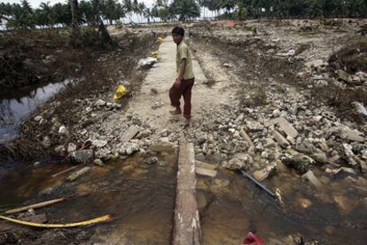 Un superviviente camina entre los restos de su población, arrasada tras el paso del 'tsunami'
