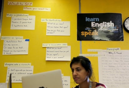 An English teacher checks assignments in a classroom at International High School in San Francisco, California, in this file photo.