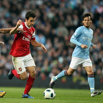 Cesc conduce el balón ante la mirada de Silva.