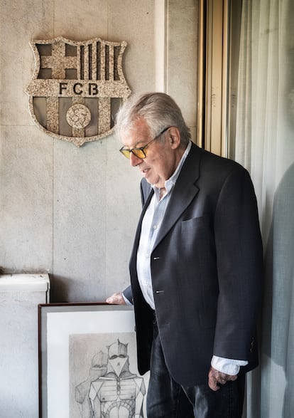 Josep María Minguella, en la terraza de su casa junto a un escudo de granito del Barça que le regaló un amigo.