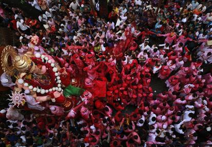 Hindu devotees participate in a procession towards the Arabian Sea where a giant idol of the elephant-headed god Ganesha will be immersed on the final day of the ten-day long Ganesha Chaturthi festival in Mumbai, India, Thursday, Sept. 15, 2016 .