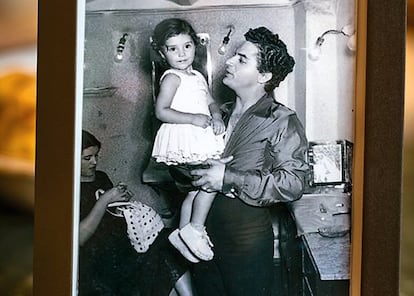 Una retrato del cantante Antonio Molina con Ángela en brazos, en su casa.