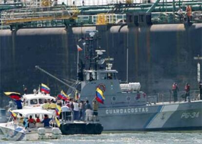 Un grupo de venezolanos blandiendo banderas muestra su apoyo a la tripulación del buque <i>Morichal</i>, que se ha declarado en huelga.(Reuters)