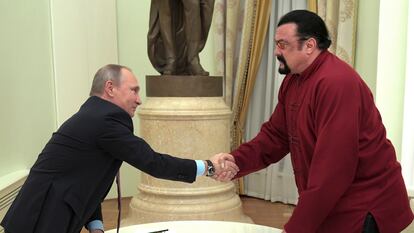 Russian President Vladimir Putin shakes hands with U.S. actor Steven Seagal in the Kremlin in Moscow, during a ceremony to award a Russian passport, Nov. 25, 2016.