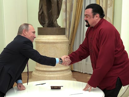 Russian President Vladimir Putin shakes hands with U.S. actor Steven Seagal in the Kremlin in Moscow, during a ceremony to award a Russian passport, Nov. 25, 2016.