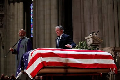 George W.Bush pasa su mano sobre el féretro del su padre, tras pronunciar su elogio durante el funeral en la Catedral Nacional.