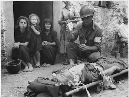 Un soldado estadounidense herido en Sicilia recibe plasma ante la mirada de civiles italianos.