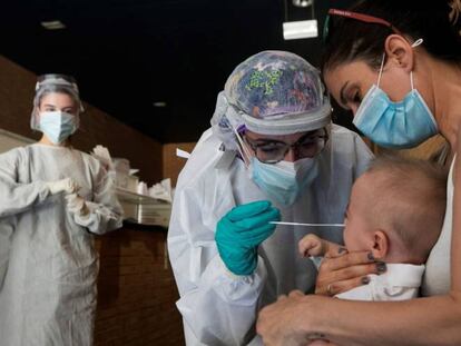 Una sanitaria realiza un test PCR a un niño en un espacio habilitado fuera de un Centro de Salud de la ciudad de Zaragoza.