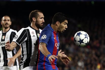 Luis Suárez (d) es presionado por Giorgio Chiellini de la Juventus.