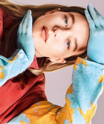 Flower print zip-up blouse, Utility vest, Blossom earrings and gloves, all from LOUIS VUITTON.