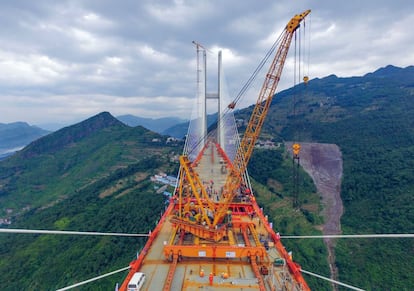 Cuando esté abierto al público, el puente de Beipanjiang superará a otro puente chino, el del río Sidu en la provincia central de Hubei, inaugurado en 2009, como el más alto del planeta. En la imagen, una grúa trabajando durante la construcción.