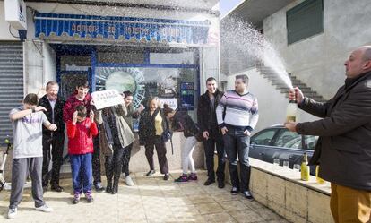 Los dueños de la administración de Loteria número 3 de la localidda coruñesa deTouro celebran el tercer premio de la Lotería de El Niño, dotado con 250.000 euros por serie que ha recaído en el número 84222.