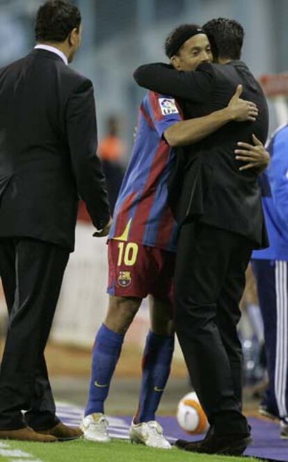 Ronaldinho se abraza con Rijkaard tras el partido.