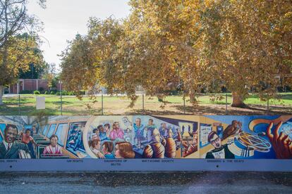 The mural is painted on the concrete wall designed to contain the Los Angeles River.