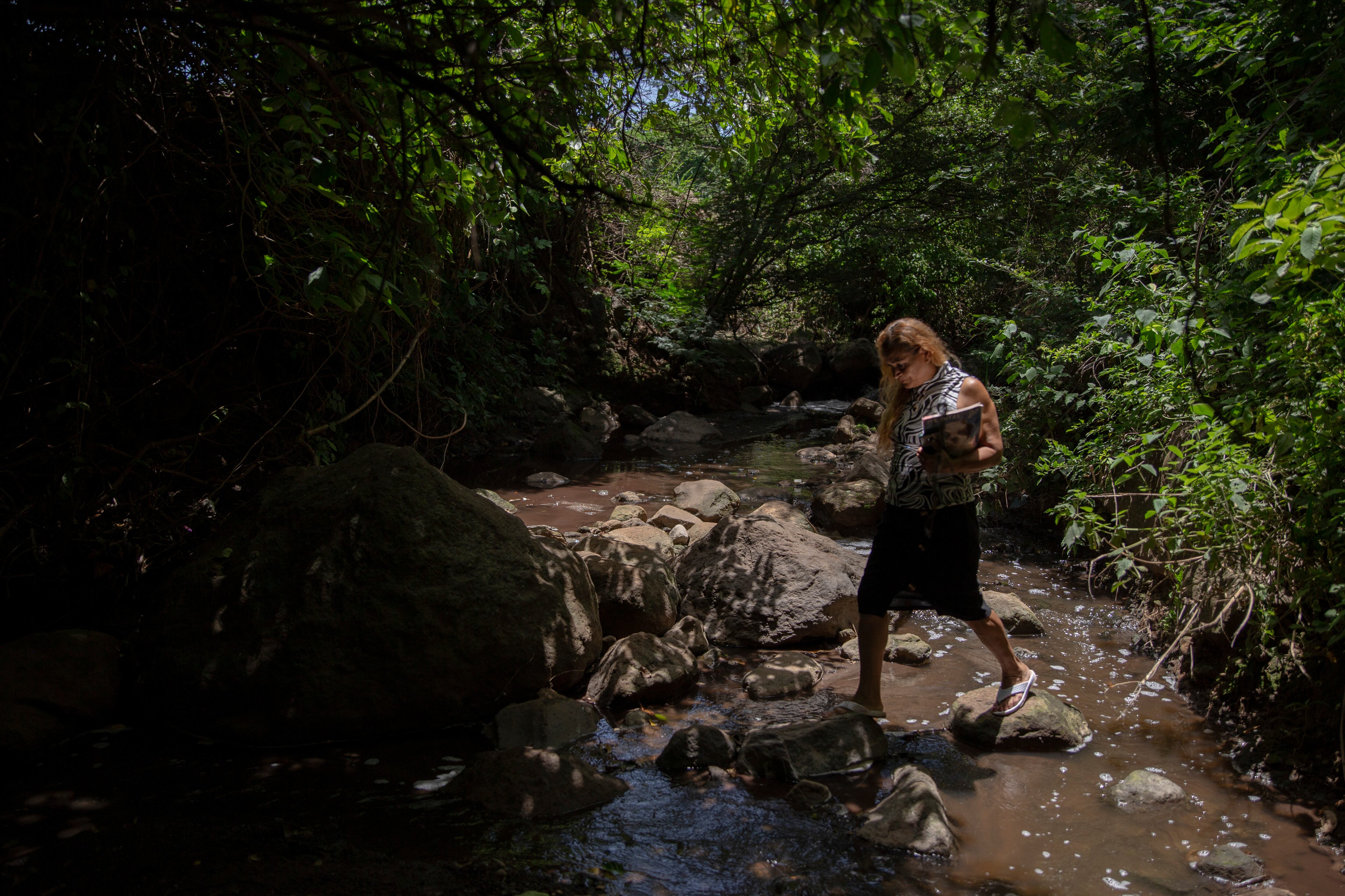 Rosa Emely Hernández, de 56 años, permanece en la quebrada que recorre en medio de la comunidad El Milagro.