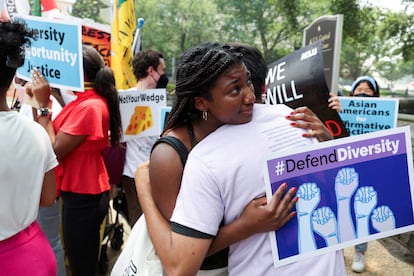 People embrace each other as demonstrators for and against the U.S. Supreme Court decision to strike down race-conscious student admissions programs at Harvard University and the University of North Carolina confront each other, in Washington, U.S.,