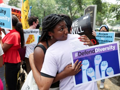 Pro-affirmative action demonstrators embrace each other in Washington, on June 29, 2023.