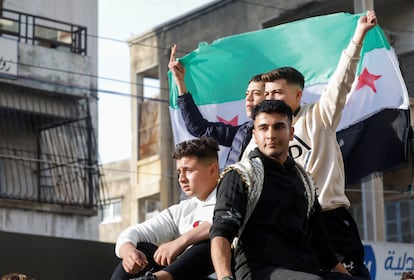 Un grupo de jóvenes lleva una bandera de la oposición siria en la localidad de Jableh, en la provincia de Latakia, al oeste del país. 