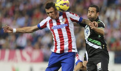 El delantero croata del Atl&eacute;tico de Madrid, Mario Mandzukic intenta un remate ante el defensa del C&oacute;rdoba, I&ntilde;igo L&oacute;pez.