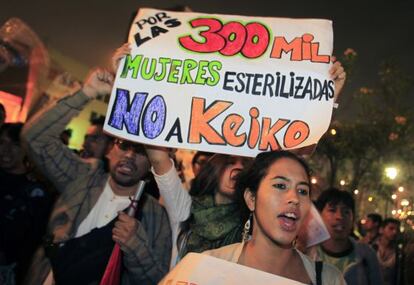People hold a sign reading: &quot;For the 300,000 sterilized women, no to Keiko&quot; before the 2011 elections. 